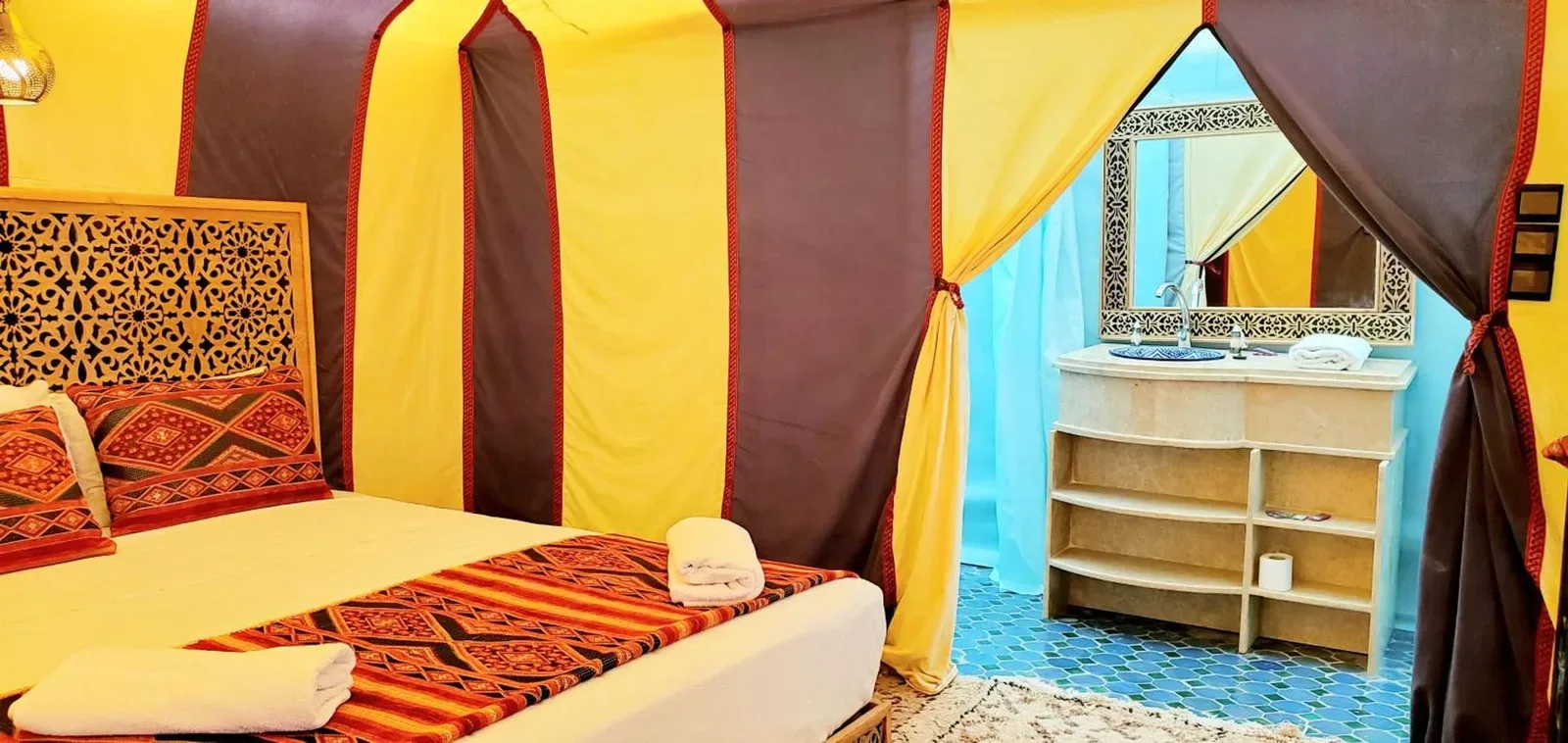 Dream luxury camp – Merzouga, Morocco hotel – a tent with two beds in a room at Dream luxury camp in Merzouga