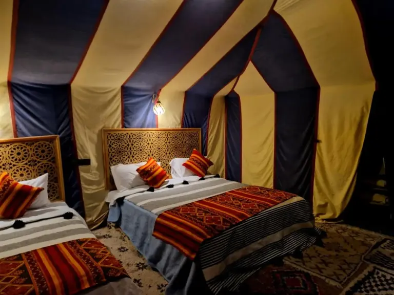 Dream luxury camp in Merzouga double bedroom with patterned bedspread and private tent interior