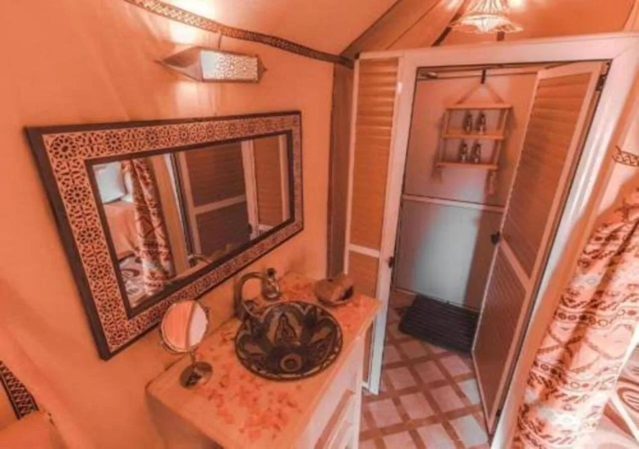 Stylish bathroom vanity at Dune Majesty Luxury Camp Merzouga with mirror and shower