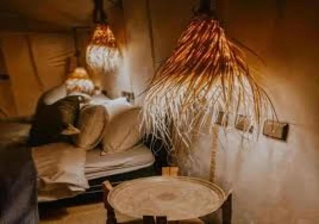 Cozy guest lounge at Dune Majesty Luxury Camp Merzouga with soft lighting