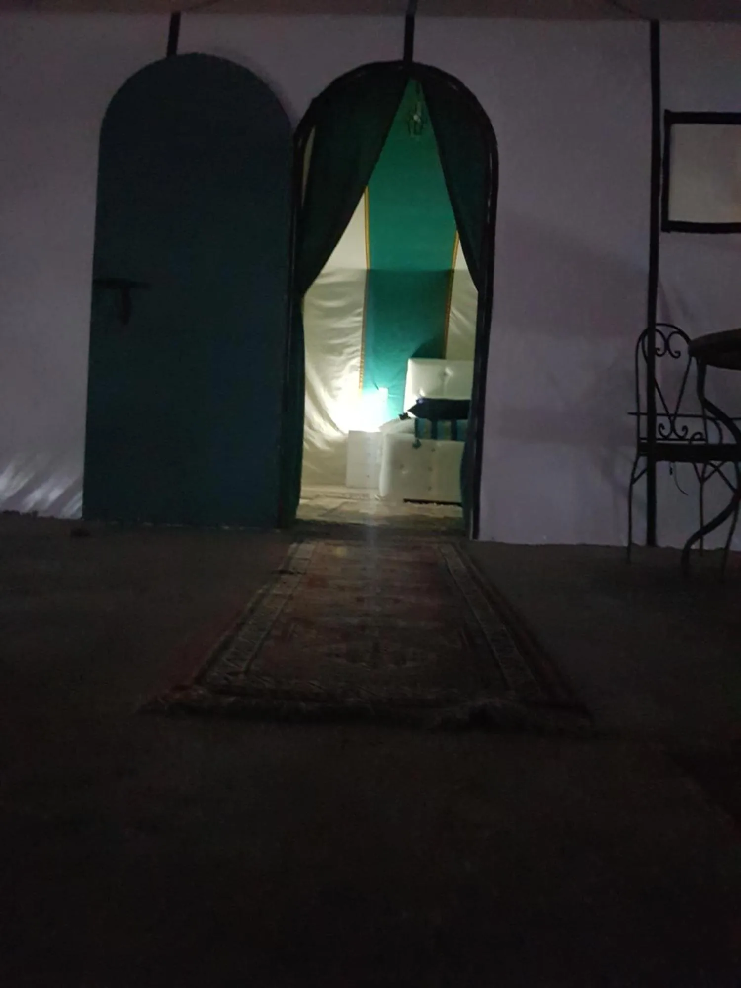 Night view of a tent entrance at Dune Merzouga Camp in Merzouga with lit interior