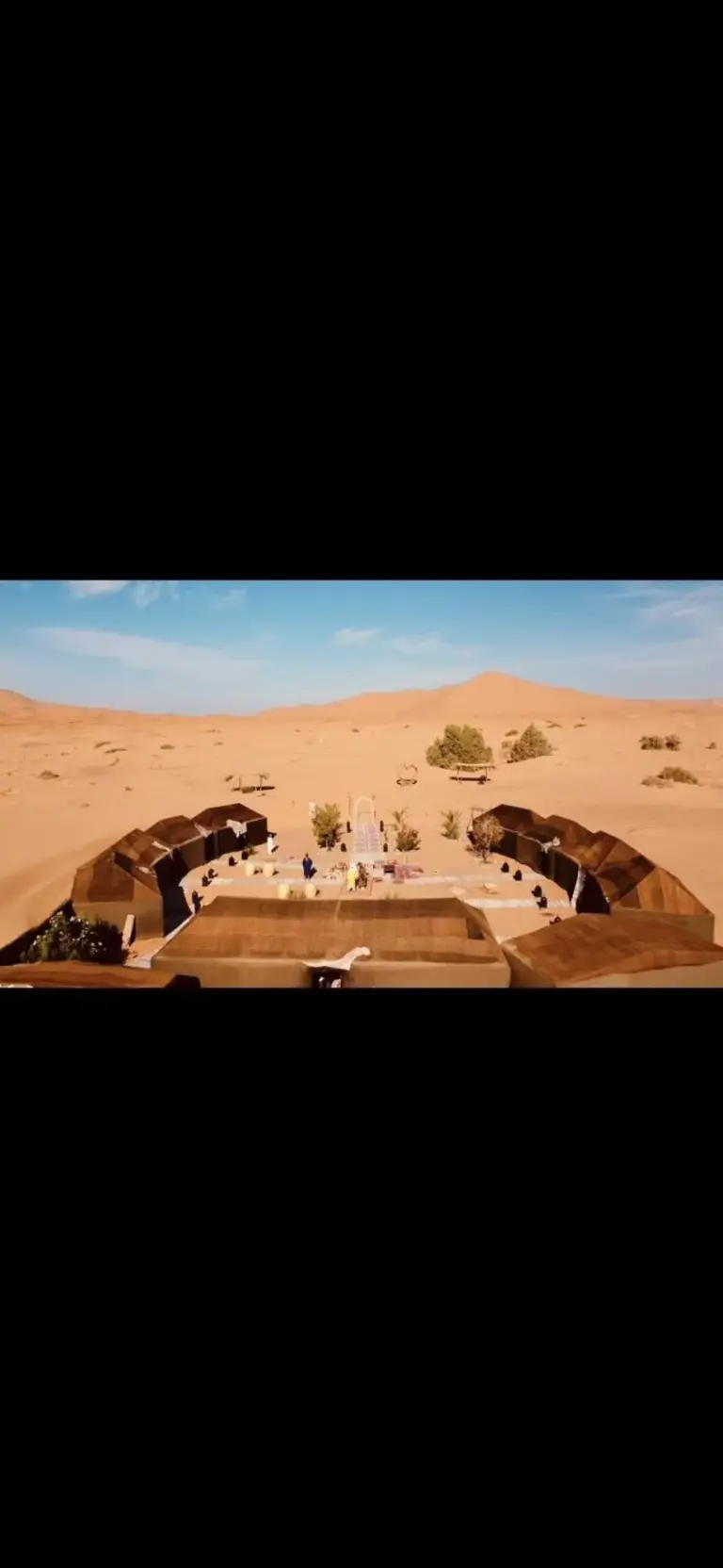 Panoramic view of Eco Merzouga luxury camp in Merzouga set among the dunes of the Sahara Desert