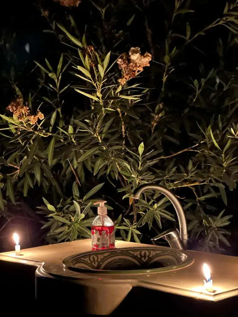 Eco Merzouga luxury camp in Merzouga outdoor sink with candles and desert plants at night