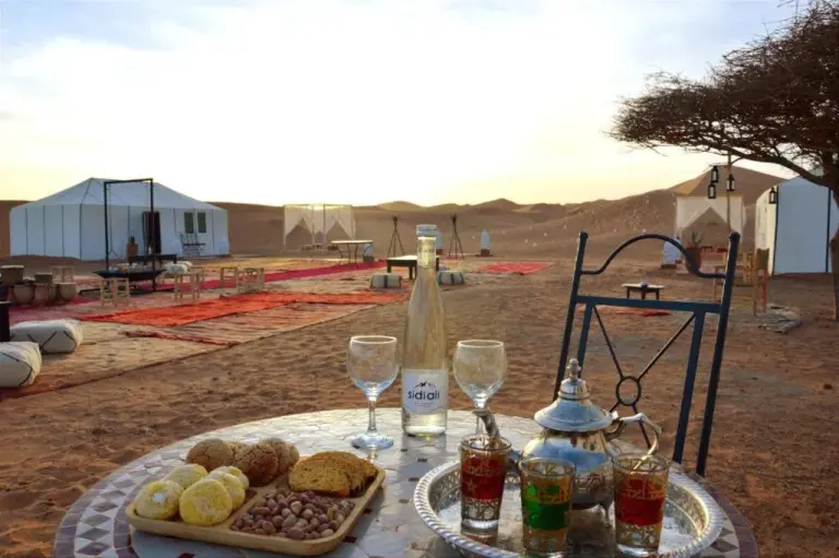 Erg Chebbi Traditional Experience & Activities in Merzouga desert camp dining setup with tea and pastries