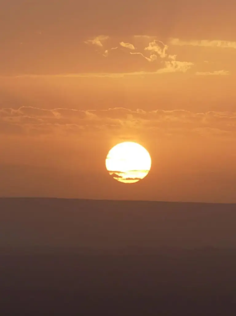 Nahaufnahme der untergehenden Sonne über den Dünen nahe Erg Luxury Camp Merzouga in Merzouga