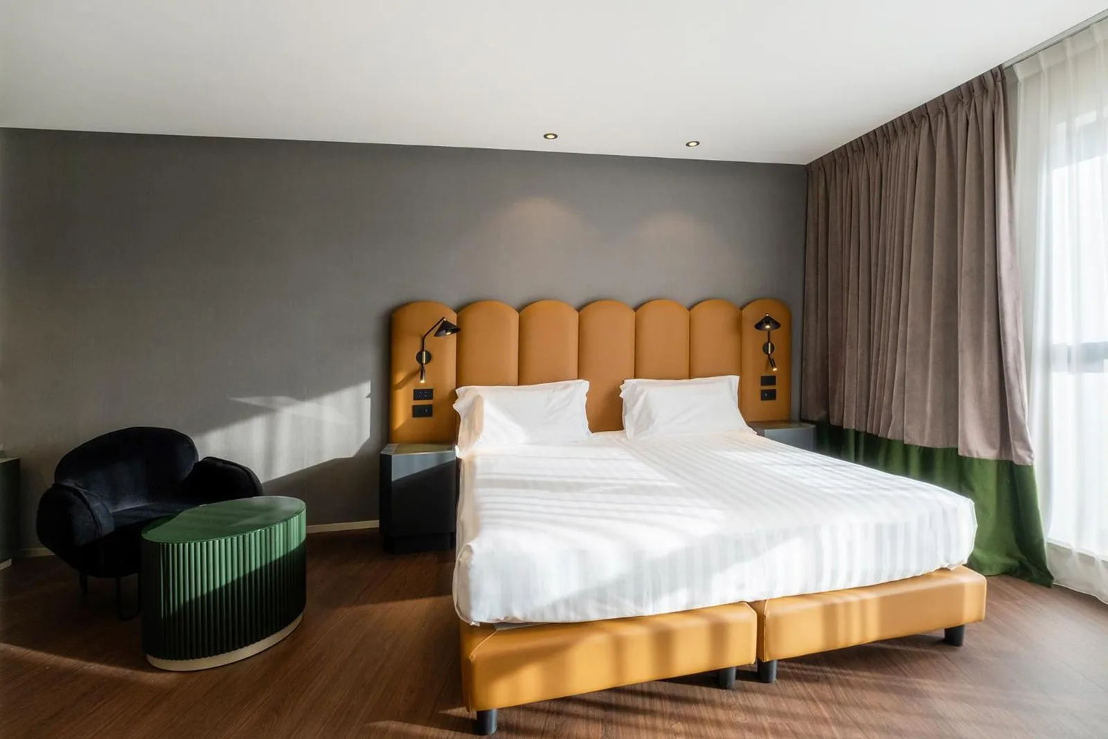 Eurostars Matera La Suite double room with orange headboard