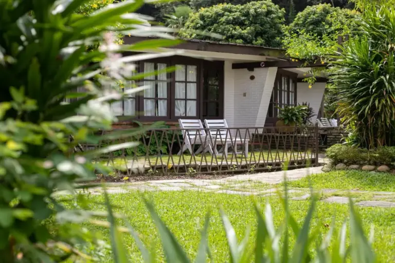 Cottage porch view at Fish Tail Lodge in Pokhara with greenery.