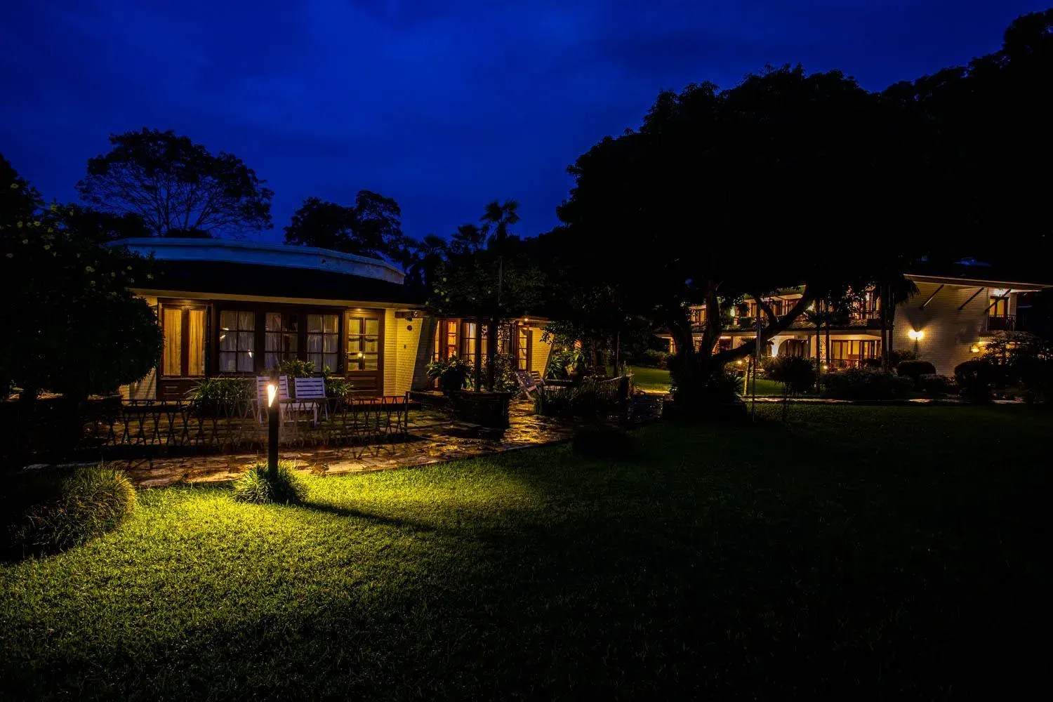 Nighttime view of Fish Tail Lodge in Pokhara illuminated by lights.