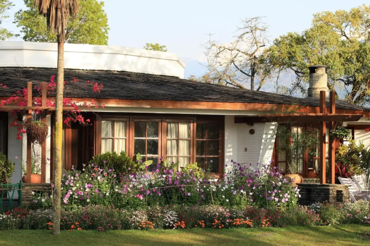 Beautiful flower garden surrounding a cottage at Fish Tail Lodge in Pokhara.