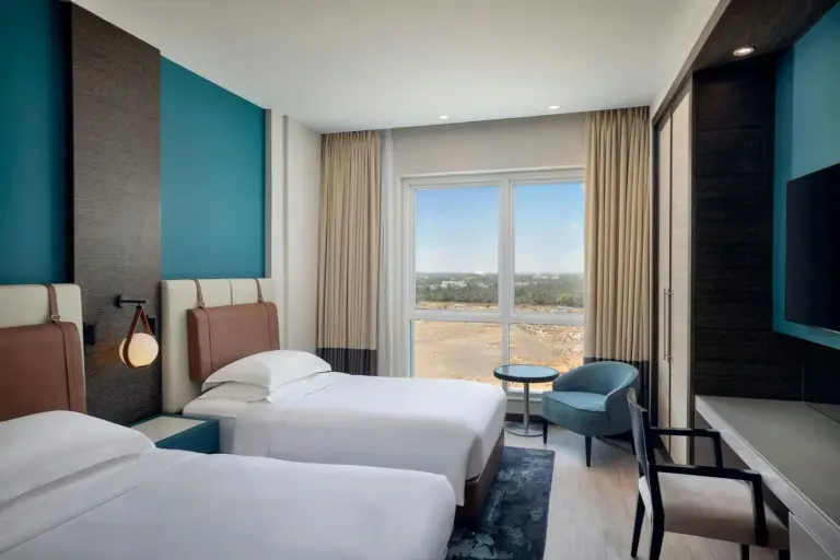Four Points by Sheraton Al Ain – Al Ain, United Arab Emirates hotel – two chairs and a table with a view of a pool at Four Points by Sheraton Al Ain in Al Ain