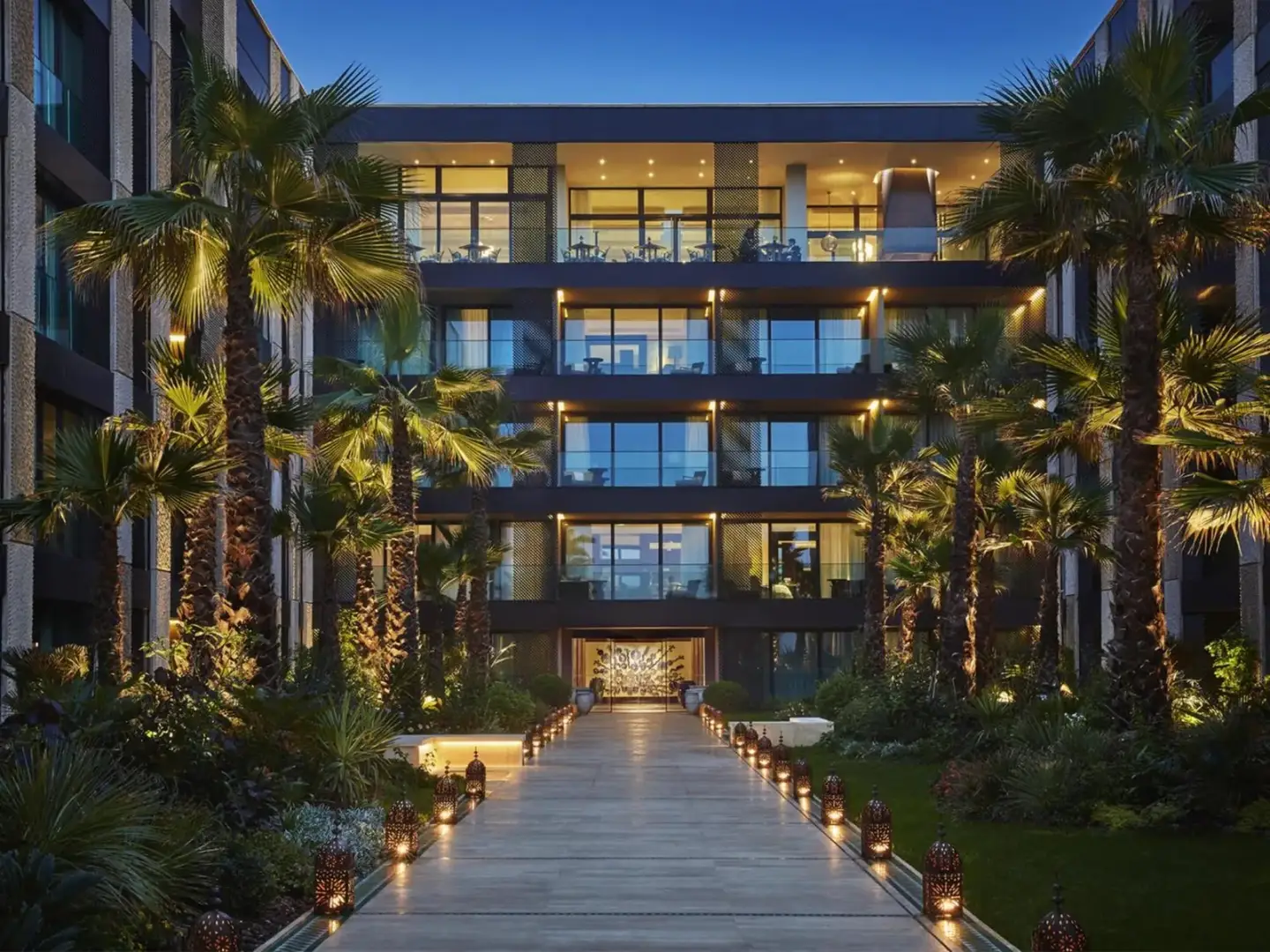 Exterior view of the Four Seasons Hotel Casablanca showing palm trees and the entrance