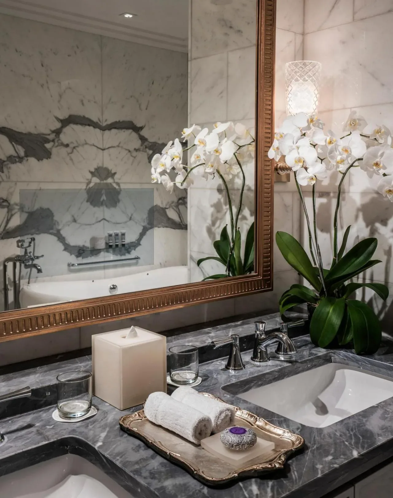 Elegant vanity with orchids in bathroom of Four Seasons Hotel Jakarta