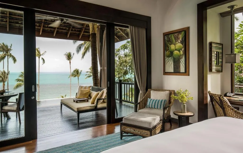 Four Seasons Resort Koh Samui – Koh Samui, Thailand hotel – a bedroom with a bed and a view of the ocean at Four Seasons Resort Koh Samui in Mae Nam