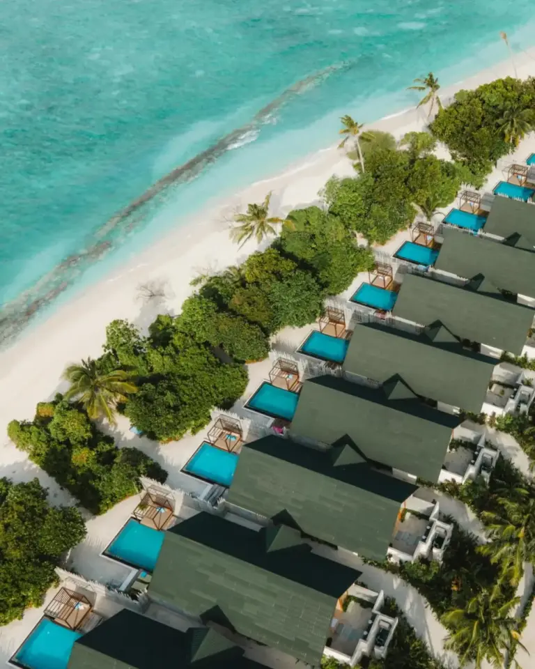 Aerial view of beachfront villas at Furaveri Maldives with the turquoise sea in the background