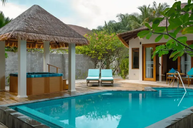 Exquisite poolside area with lounge chairs at Furaveri Maldives