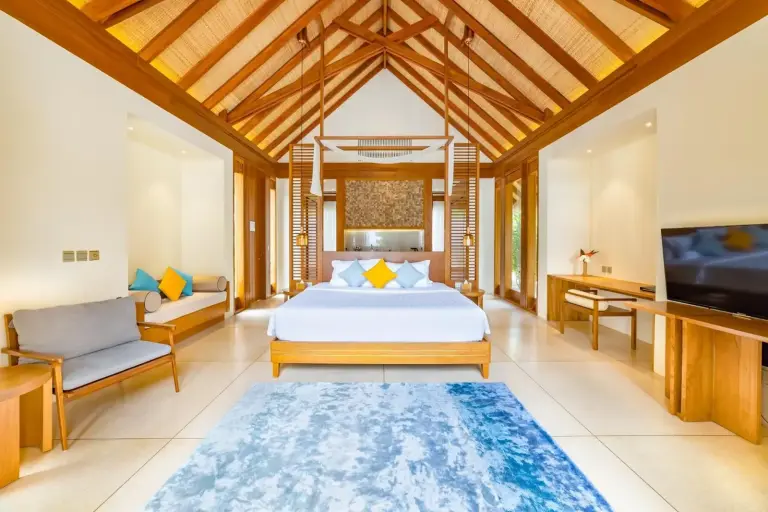 Spacious bedroom interior with modern decor at Furaveri Maldives