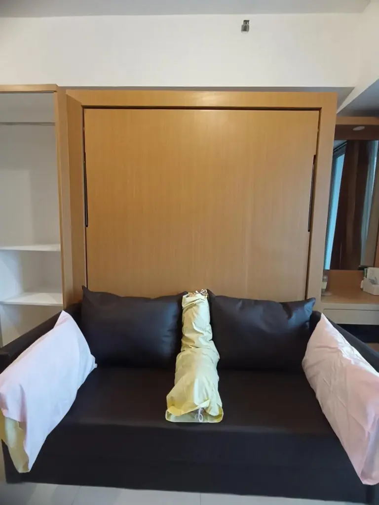Gatotkaca Hotels Surabaya bedroom interior with large bed, window, and wall-mounted TV