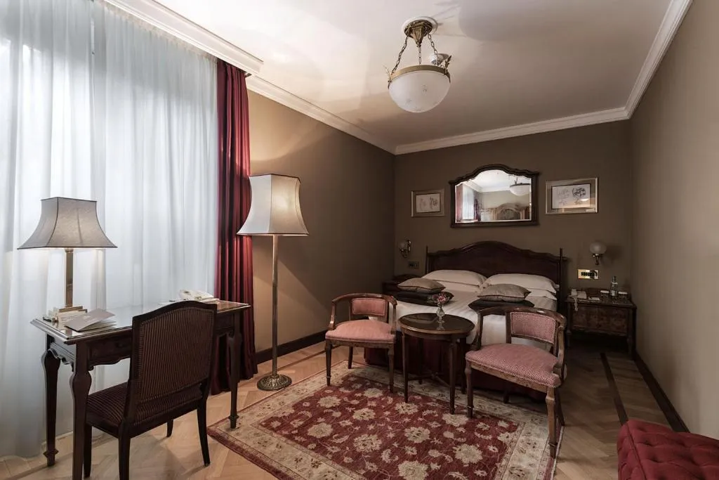 Grand Hotel et de Milan classic bedroom with cozy seating