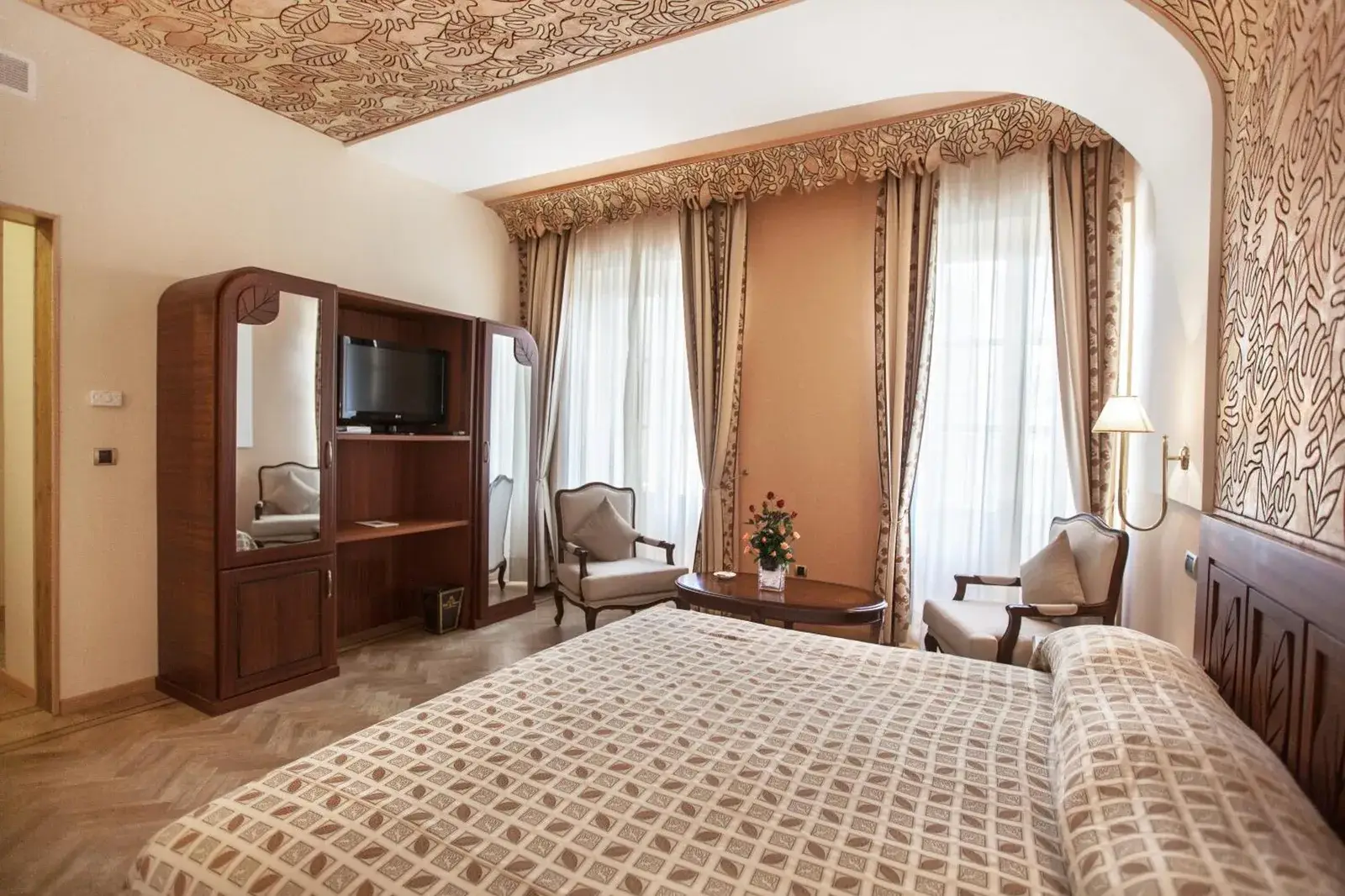 Chambre Deluxe au Grand Hotel Villa de France avec télévision et coin salon