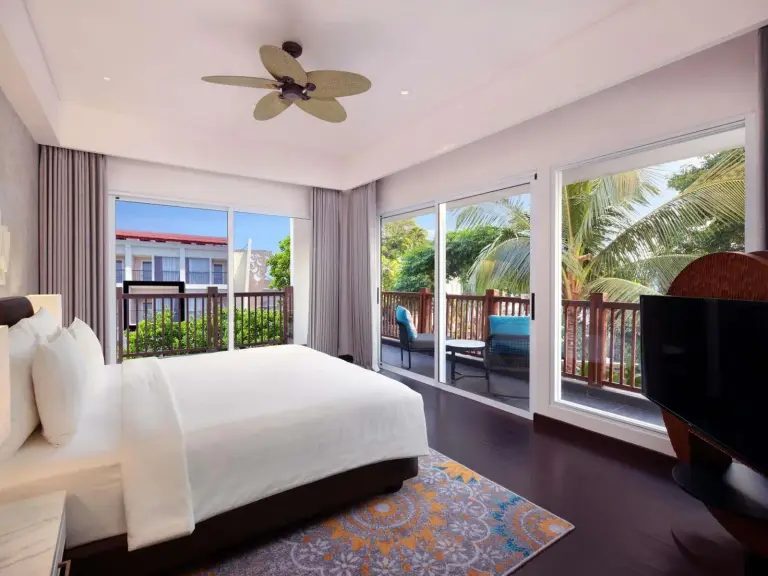 Bright bedroom with balcony view at Grand Mercure Bali Seminyak