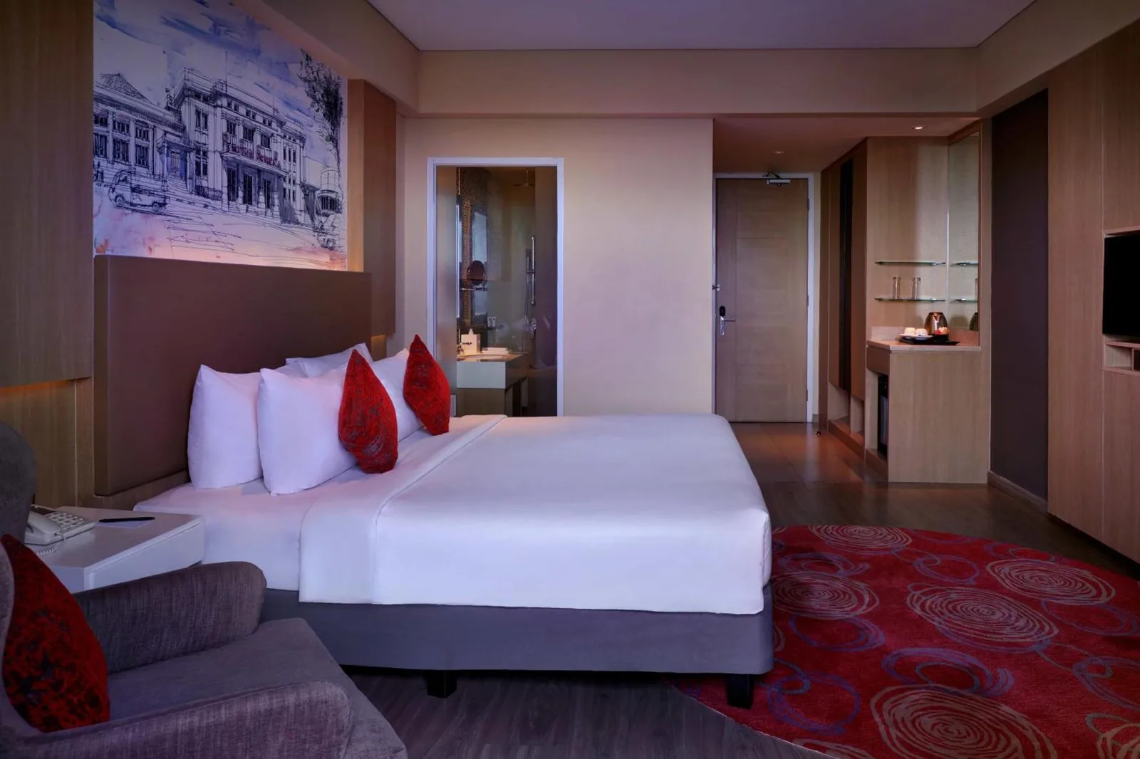 Guest room at Grand Mercure Bandung Setiabudi in Bandung with bed, bathroom access, and red patterned carpet