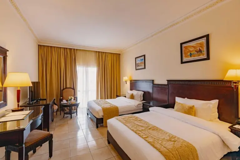 Grand Mogador Aqua Resort – Marrakech, Morocco hotel – a hotel room with two beds and a television at Grand Mogador Aqua Resort in Marrakech
