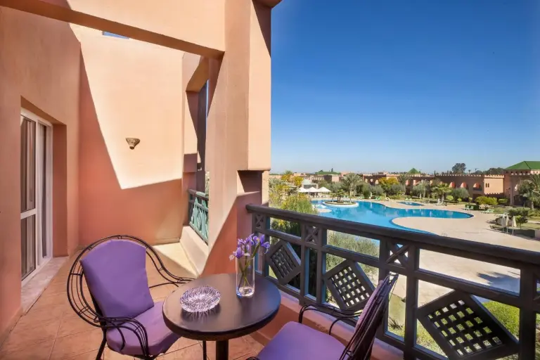 a large bedroom with a large bed and a couch at Grand Mogador Aqua Resort in Marrakech