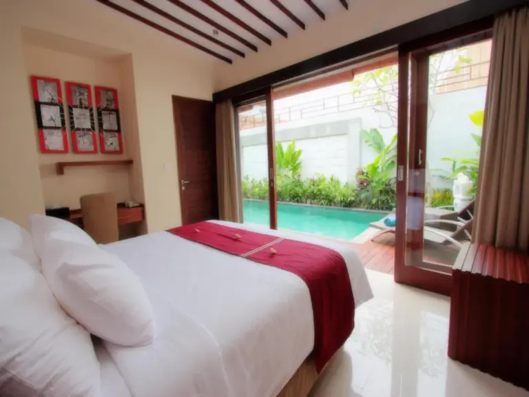 Poolside bedroom at Grania Bali Villas in Seminyak with direct access to the outdoor pool.