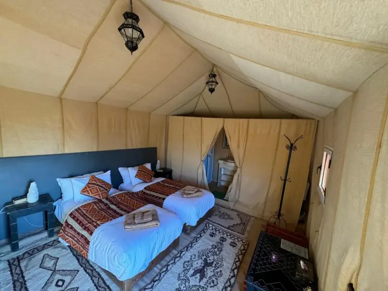 Interior setup of a tent at Hagra Luxury Camp Merzouga