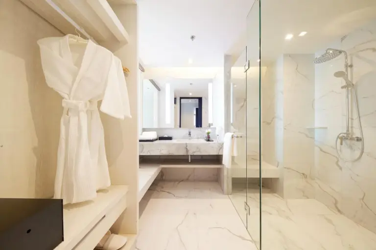 Modern bathroom at Health Land Resort & Spa Pattaya with walk-in shower, vanity, and marble finishes