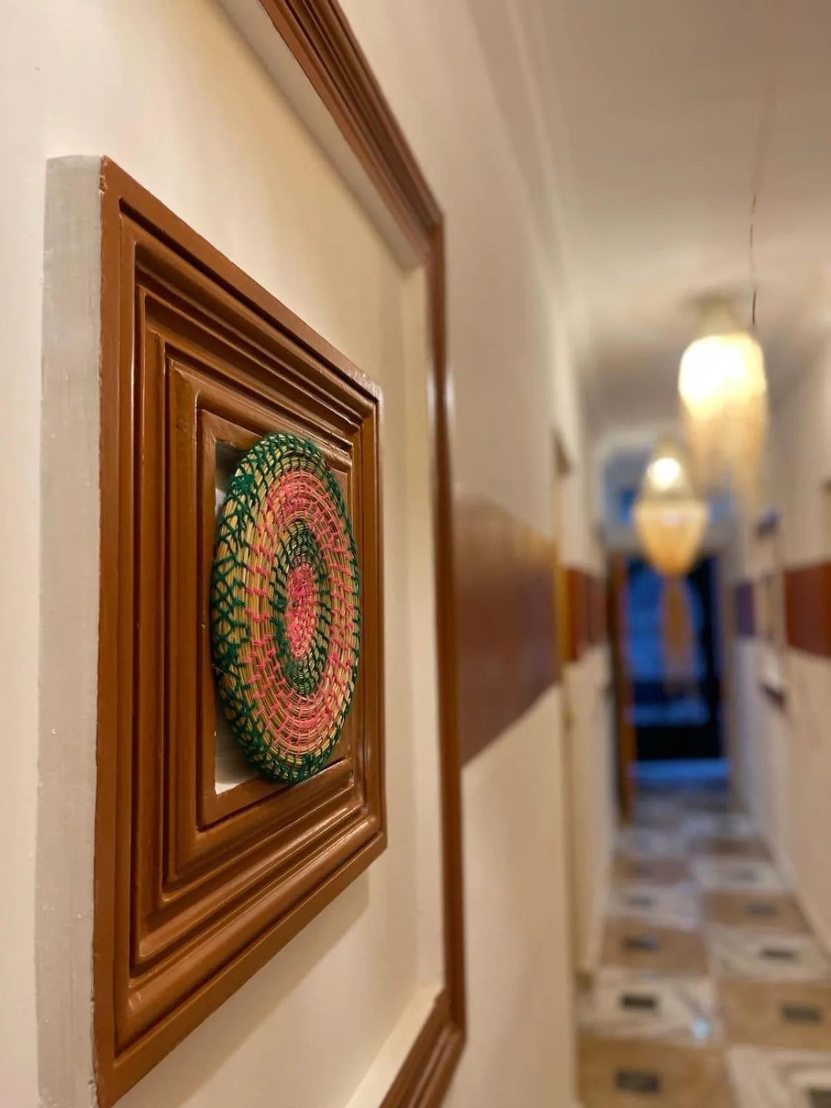 Close-up hallway detail at Heaven Surf Camp in Agadir with framed wall art and patterned corridor