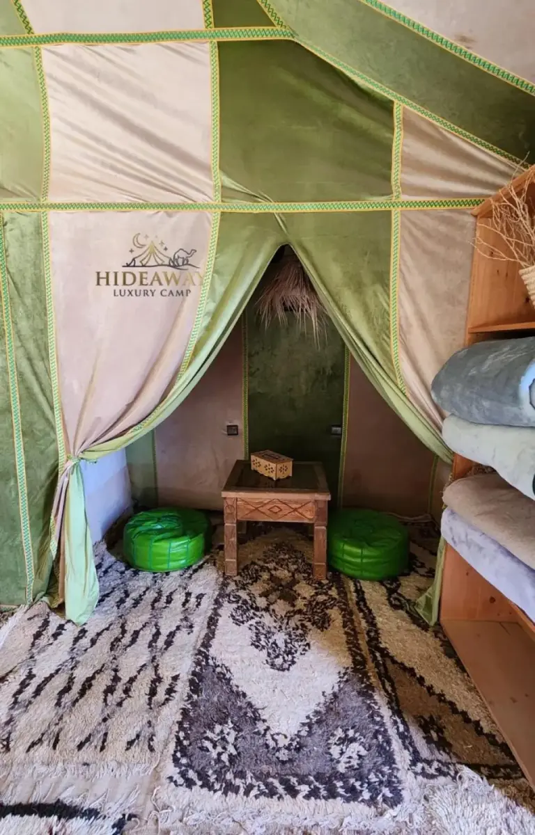 Seating area inside a tent at Hideaway Luxury Camp