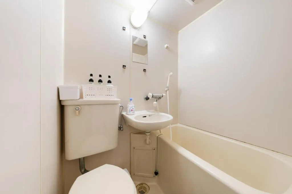Compact bathroom in the hotel with essential amenities.