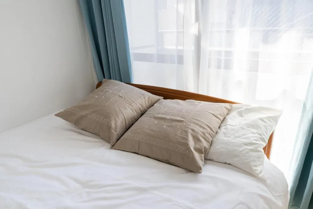 Close-up of pillows on the bed in the hotel room, showcasing comfort.