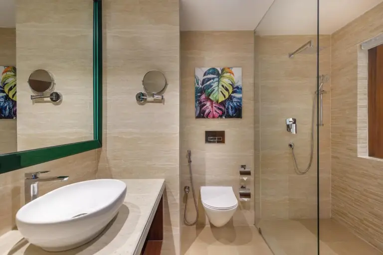 Contemporary bathroom at Holiday Inn Resort Kathmandu Budhanilkantha by IHG with glass shower, vessel sink, and wall art.