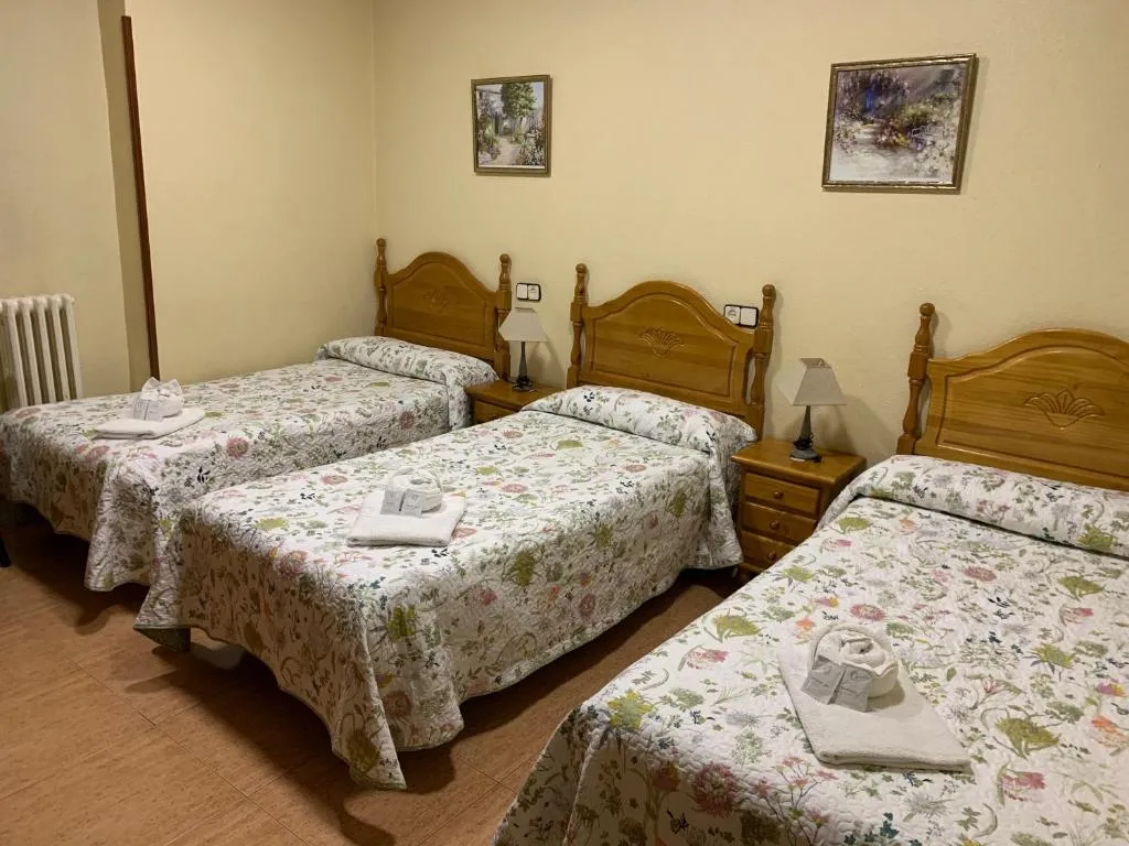 Triple room with floral decor at Hostal Internacional in Madrid