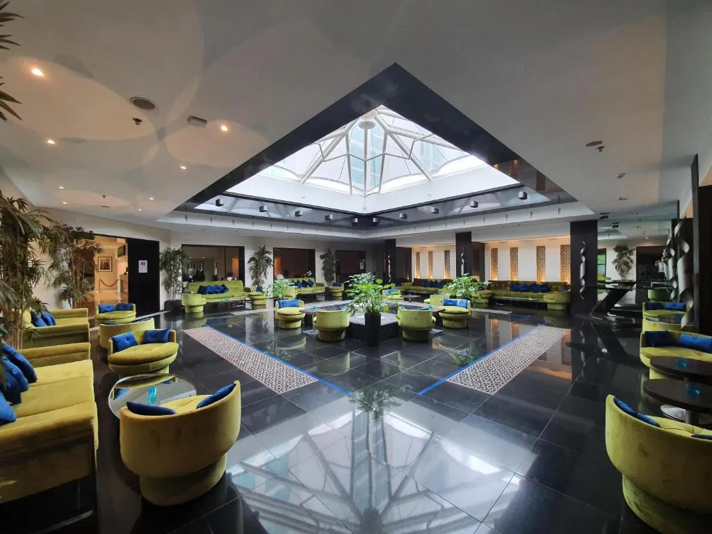 Lobby lounge area at Hotel Borj Rabat with plants and seating