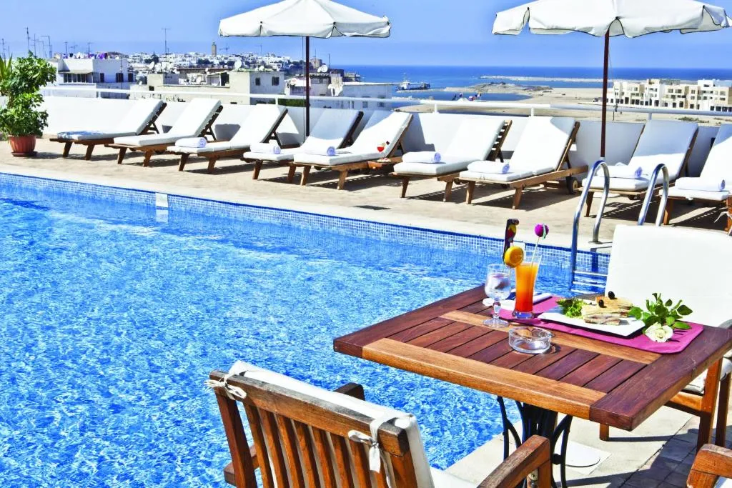 Poolside view with refreshments at Hotel Borj Rabat