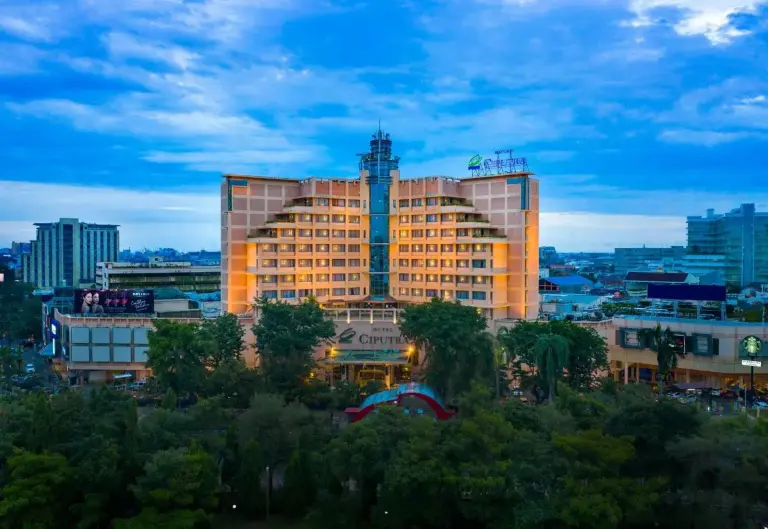 Exterior view of Hotel Ciputra Semarang in Semarang with the illuminated facade at dusk