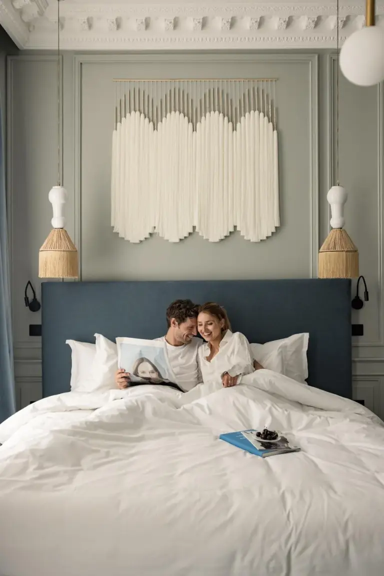 Couple enjoying time in bedroom at Hotel des Quinconces Bordeaux Centre