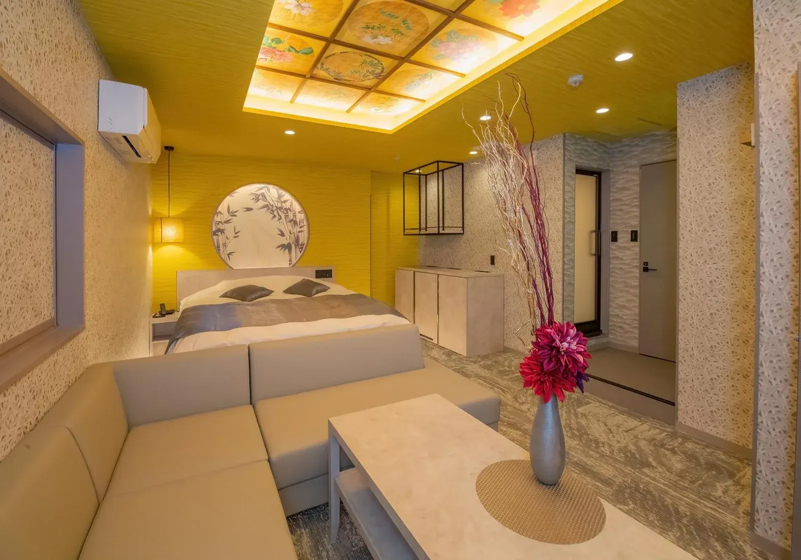 Stylish guest room at Hotel Kaguya in Himeji with a bed, sofa seating, and modern mural wall decor.