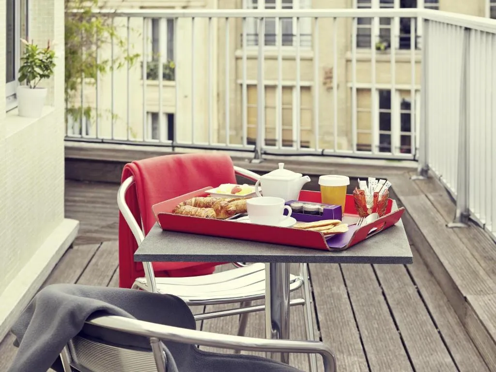 Breakfast setup on the balcony at Hôtel Relais de Lyon By Malone