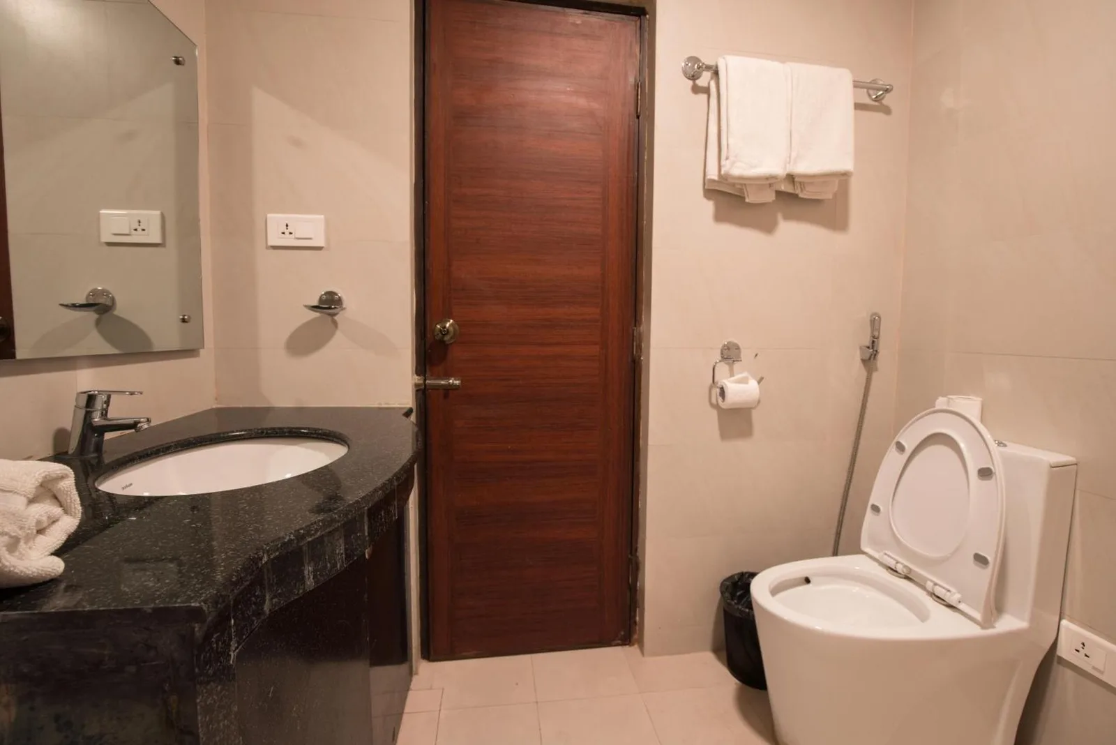 Hotel Shaara Pokhara deluxe room with large bed and lounge chairs