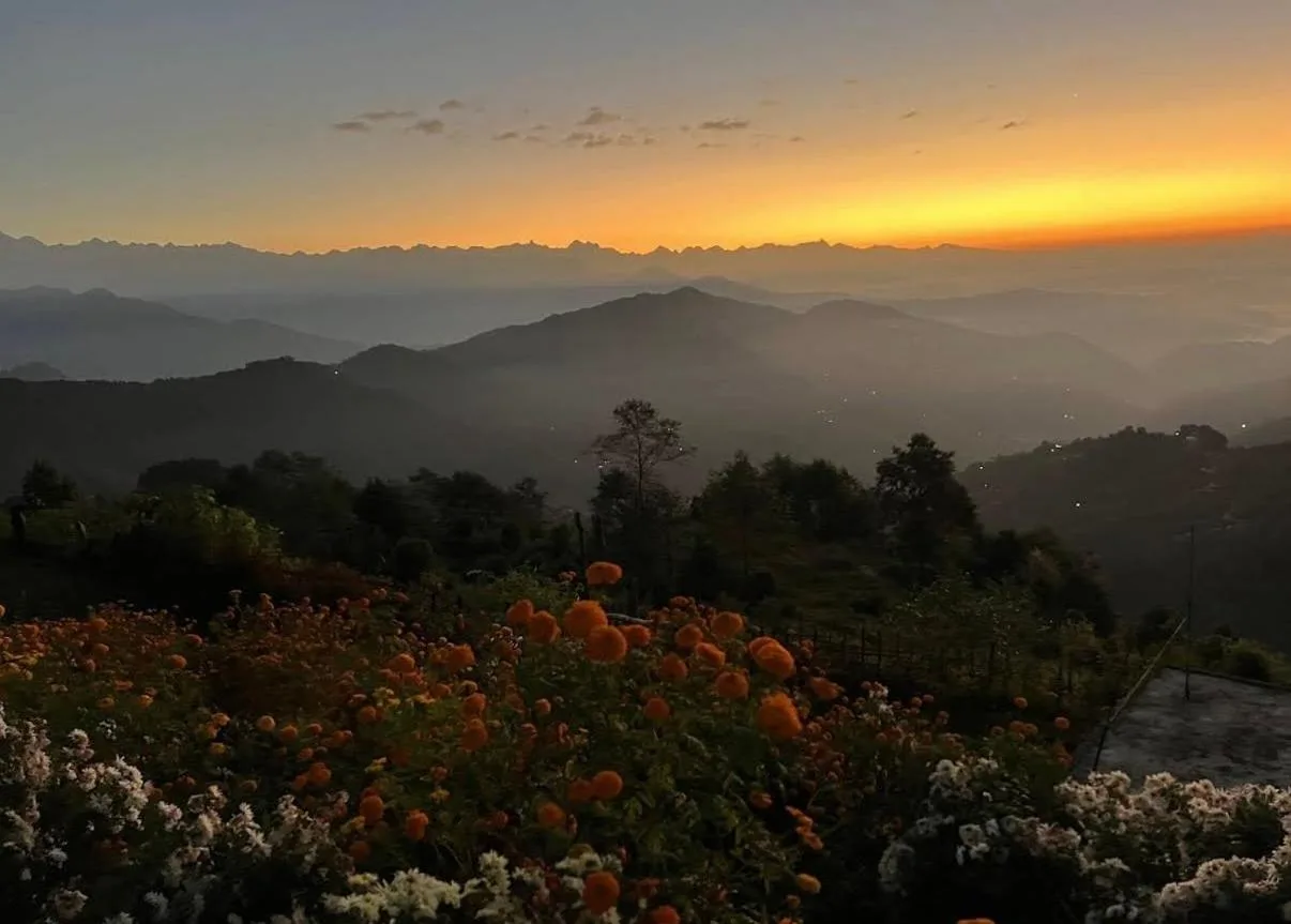 Sonnenuntergang über den Hügeln vom Hotel Shangbola in Bhaktapur mit Blumengarten im Vordergrund
