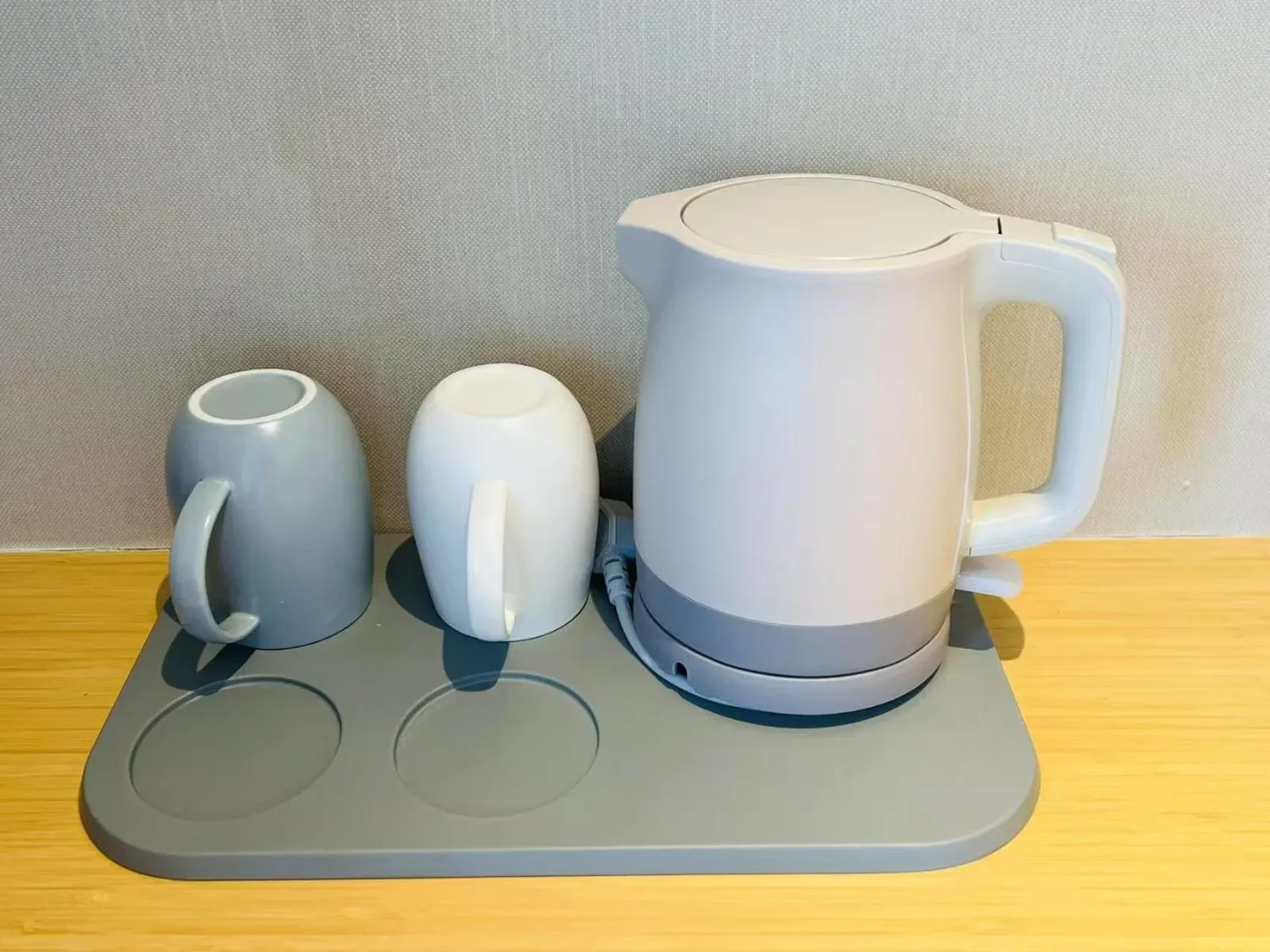 Tea and kettle station in a guest room at Bangkok Oriental Hotel in Bangkok with cups and electric kettle.