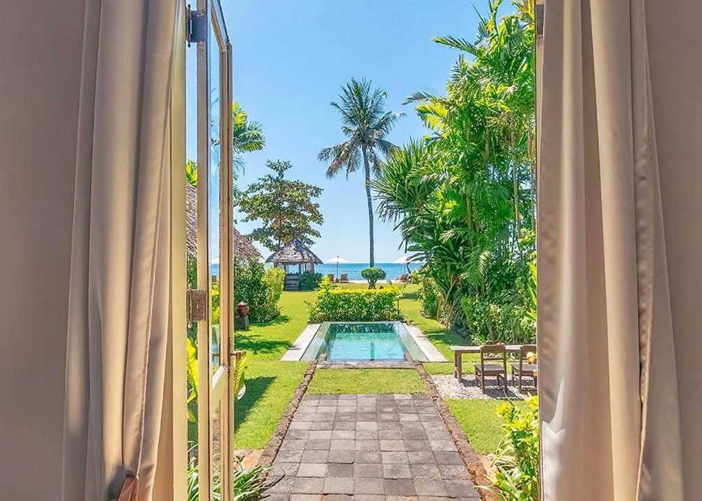 View from room in Hotel Tugu Lombok to lush garden and pool
