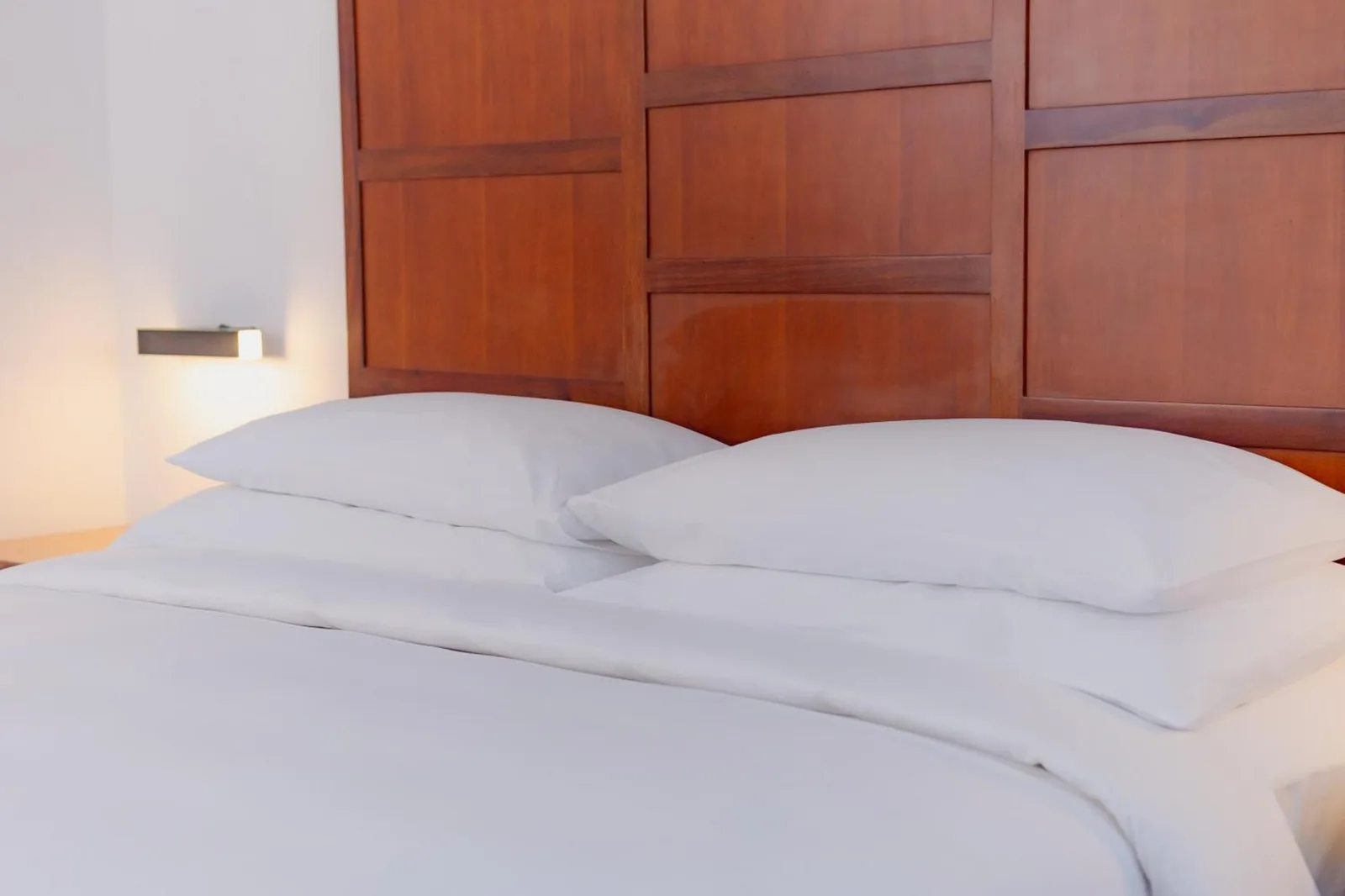 Hulhule Island Hotel bed showcasing plush pillows