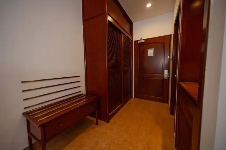 Entrance to a room at Hulhule Island Hotel with wooden accents