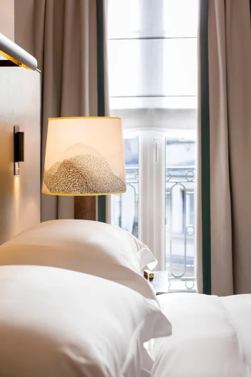 Stylish bedside lamp in a guest room at Hyatt Paris Madeleine