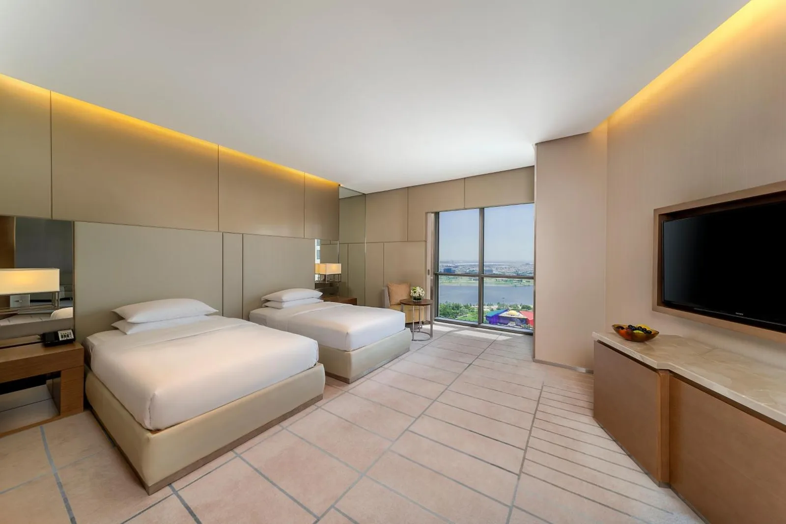 Bathroom vanity at Hyatt Regency Dubai Creek Heights in Dubai with large mirror, bathtub, and city view